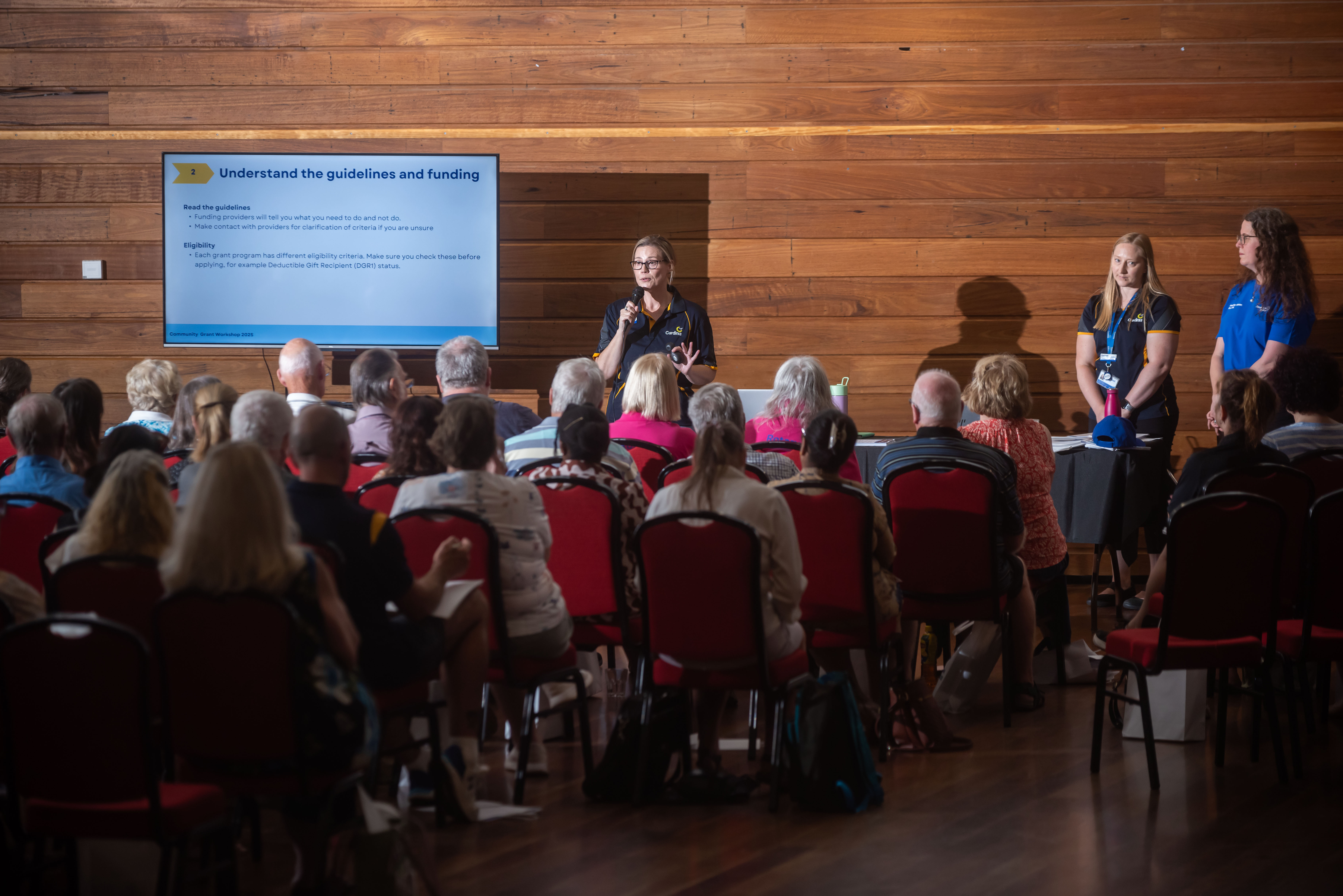 Community members attentively listening during the grant expo information session.