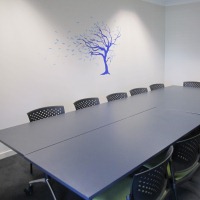 A medium size table surrounded by chairs