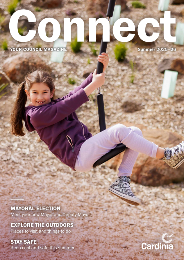 A child rides a playground flying fox above a landscaped outdoor area, featured on the cover of Connect, Cardinia&rsquo;s council magazine for Summer 2025&26.
