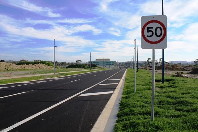 Siding Avenue, Officer, opened October 2017. Image shows road facing north, with a 50km/h speed limit sign in the foreground and the Council Civic Centre in the background.