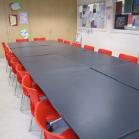 Long desk surrounded by chairs