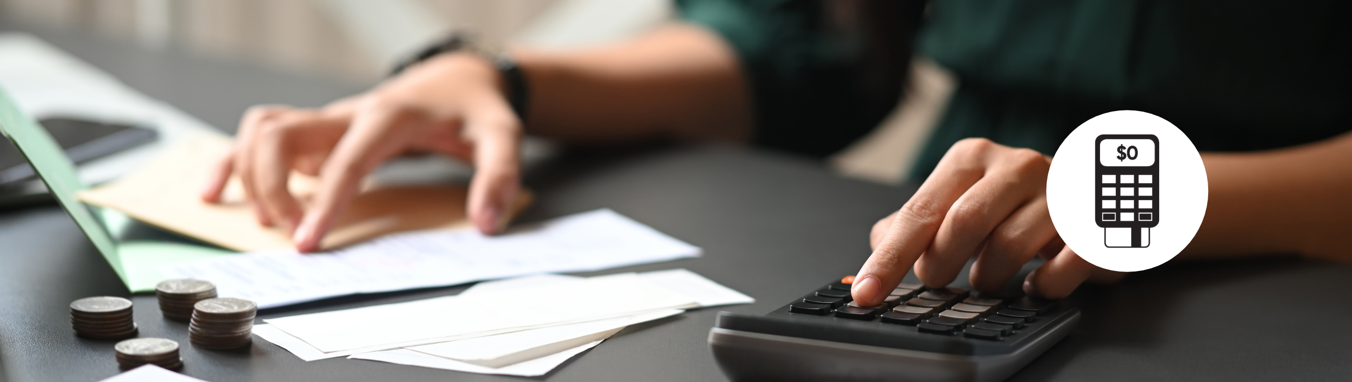 person using a calculator with paperwork